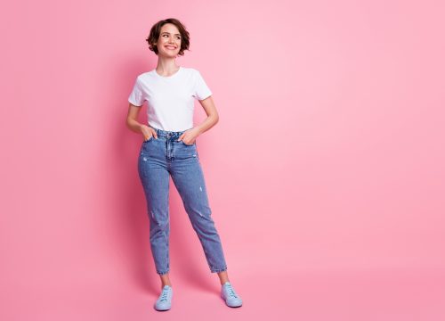 Photo of a thin woman wearing a white shirt and blue jeans