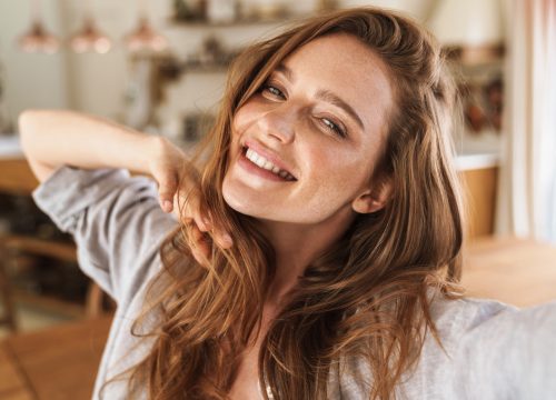 Picture of young smiling beautiful woman after CoolSculpting® for double chin treatments