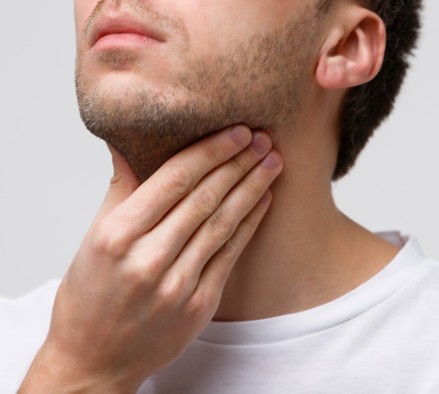 Photo of a man touching his submental area