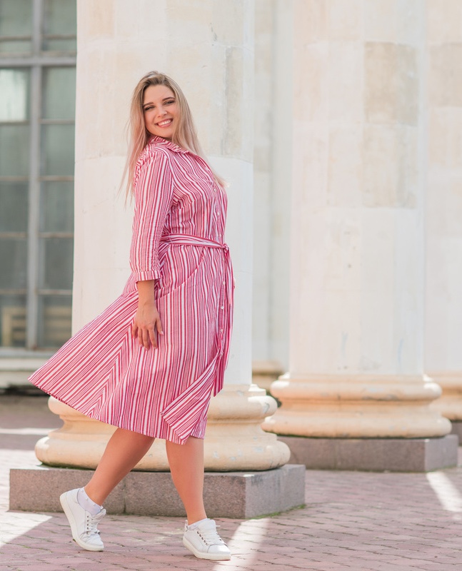 Photo of a happy woman in a pink dress