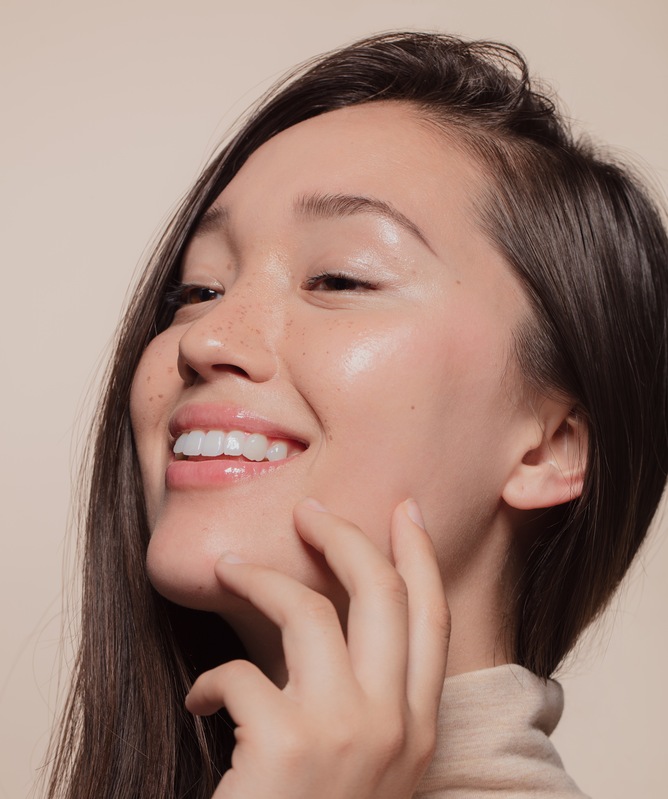 Close up of beautiful woman touching her face. 