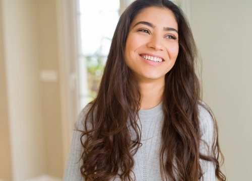 Beautiful brunette woman smiling cheerful, looking happy and positive after GentleMax Pro treatments