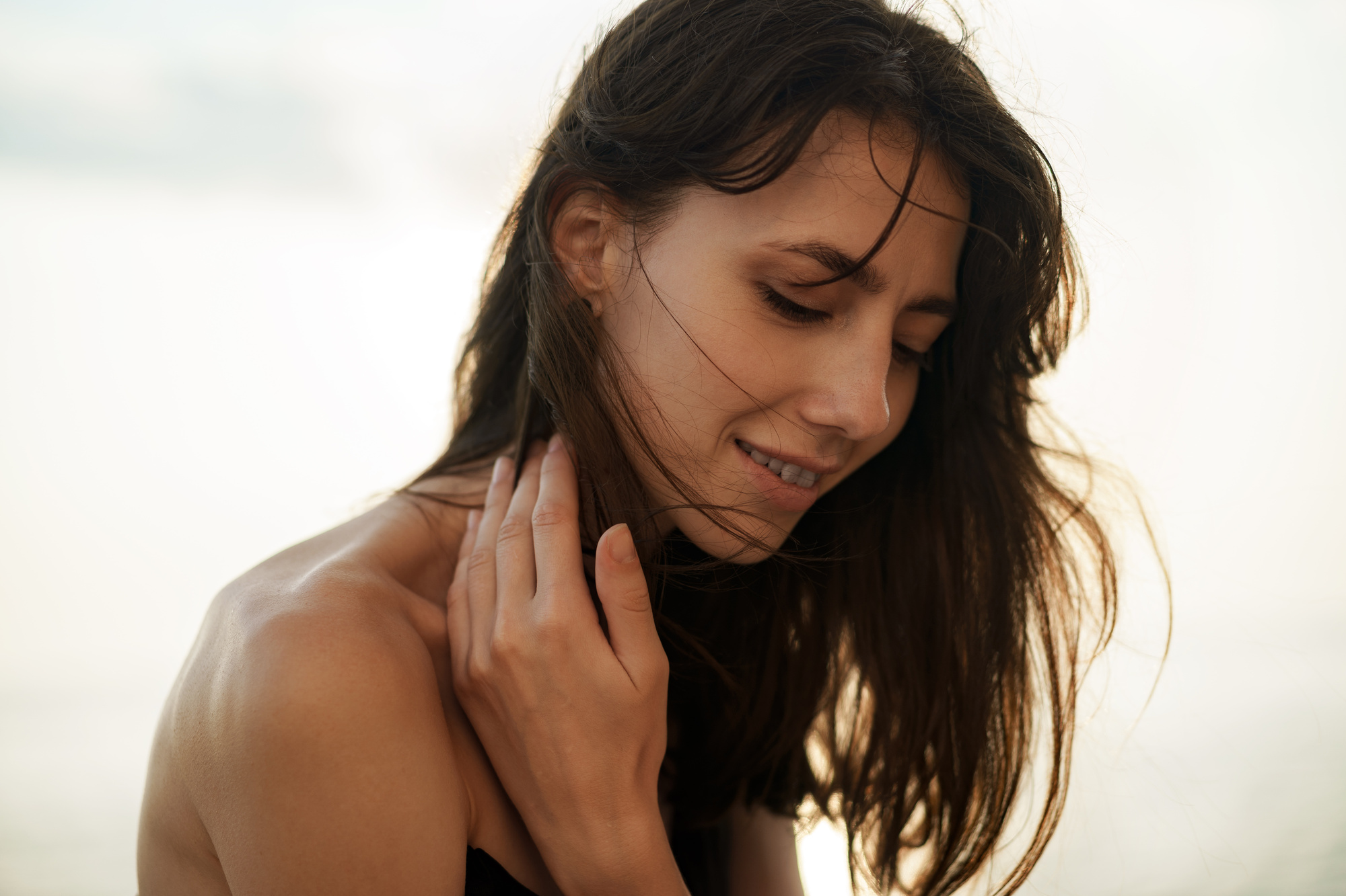 Young smiling woman outdoors portrait at the beach after a sublative skin treatment